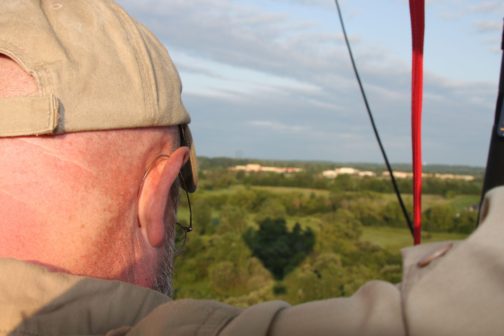 Lake Geneva Balloon Company pilot John Trione looks out at this flight path with the shadow below